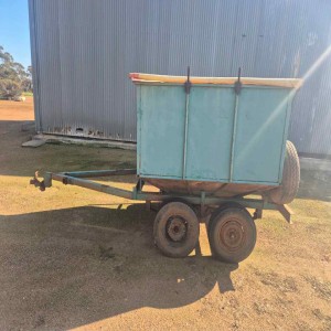 Sheep feed out trailer with roll tarp